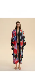 Detail of artistic abstract watercolor print on satin robe with wide sleeves