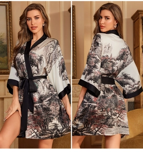 Detail of satin robe featuring Chinese landscape print and black silk-like trim accents