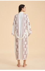 Detailed back view of white floral satin robe with ethnic brown print and waist belt