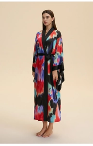 Detail of colorful satin bathrobe showing silk texture and black trim on wide sleeves