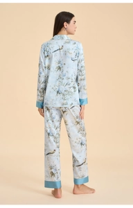 Rear view of floral print pajamas set featuring elegant silk-like fabric and contrast piping
