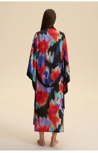 Detail of artistic floral print and long loose sleeves on a satin kimono robe