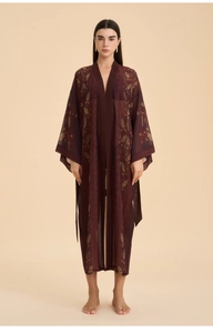 Detail view of burgundy chiffon long robe with gold leaf print and bohemian patterns