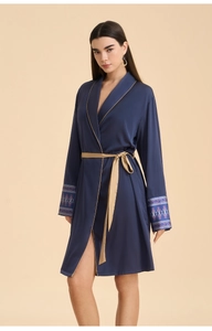 Detailed view of navy blue satin robe featuring gold piping and ethnic pattern on cuffs
