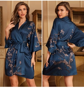 Detail view of dark blue satin floral robe featuring elegant cherry blossom patterns