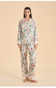 Detail of floral satin pajama set featuring a notch collar and contrast trim cuffs