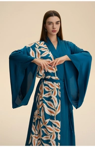 Detail of navy blue satin robe with large leaf print, v-neckline and wide flared sleeves