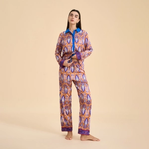 Women's ethnic ikat print satin pajama set with long sleeves and pants in orange tones