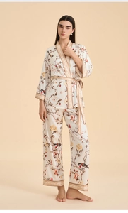 Detail of floral satin pajama set featuring a wrap top with bird and flower patterns