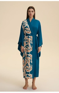 Detail view of women's silk satin long robe with bohemian leaf print and waist tie