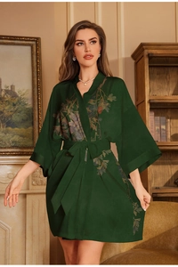 Detail of dark green satin floral bathrobe with wide kimono sleeves and waist tie