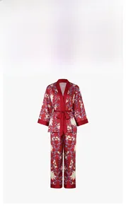 Detail of red floral satin loungewear set with silky texture and intricate vine patterns
