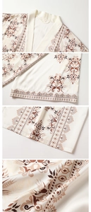 Macro view of silky satin robe fabric with vintage floral patterns and smooth textures