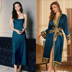 Detail of luxurious peacock blue satin robe with ornate gold embroidery on cuffs and hem