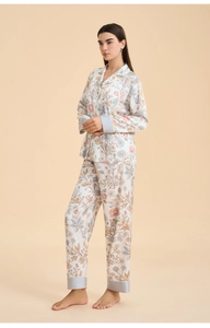 Detail of elegant floral pajama set featuring a button-down collar and satin fabric texture