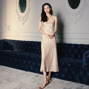 Detail of elegant champagne satin slip dress featuring cowl neck and thin shoulder straps