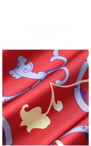 Detail of red floral satin fabric material with elegant purple and green patterns