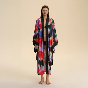 Elegant long satin kimono robe with colorful tie-dye print and black trim for women