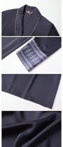Detailed close-up of dark blue satin robe with golden piping and floral embroidery