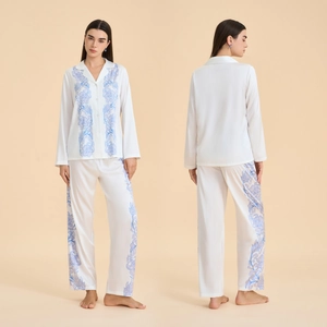 Women's ivory satin pajama set with blue floral prints featuring long sleeve top and pants