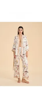 Detailed view of floral satin pajama set featuring silk-like kimono top and straight pants