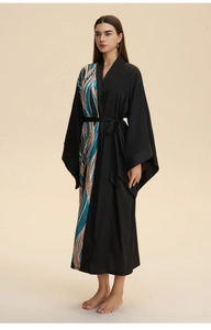 Detail of luxurious long satin robe featuring chic abstract feather pattern side panels