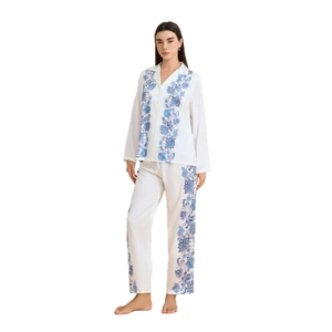Women's two-piece satin pajama set featuring white floral print long sleeve top and pants