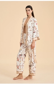 Detail of floral satin robe set showing premium bird print and jacquard borders
