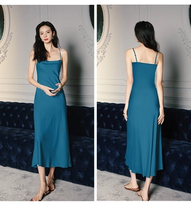 Detail of silk peacock blue slip dress with cowl neck and elegant fishtail drape