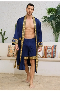 Close-up of navy satin robe set with ornate gold baroque patterns on sleeves and hem