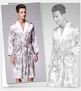Detail of silver silk-satin robe featuring intricate baroque patterns and smooth texture