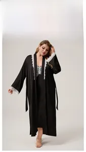 Detail of plus size black satin robe featuring elegant white lace trim on sleeves
