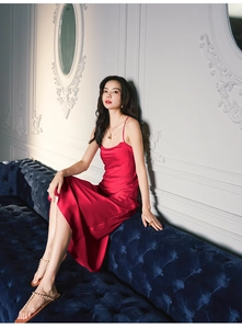 Chic red satin slip dress shown against a velvet blue sofa for premium home aesthetic