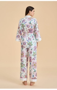 Detail of floral print satin pajamas set featuring bohemian purple and green flowers
