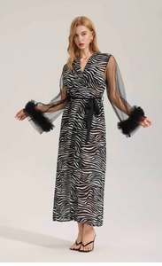 Close-up of zebra print chiffon robe with mesh sleeves and luxury feather trim at cuffs