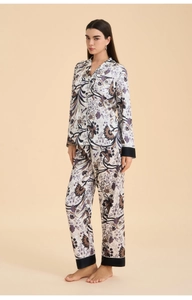 Detail view of floral pajama set featuring elegant notched collar and contrast piping trim