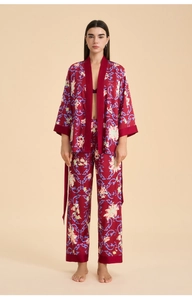 Detail of burgundy satin floral bathrobe set with intricate blue scroll patterns