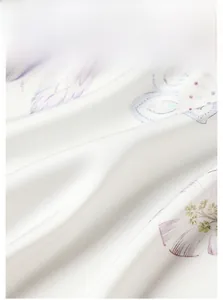 Macro shot of satin fabric material with elegant feather and floral digital prints