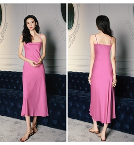 Detail view of pink satin slip nightdress with slim straps and draped elegant fabric