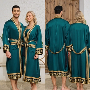 Detail of emerald green satin robe set featuring gold baroque patterns and waist tie