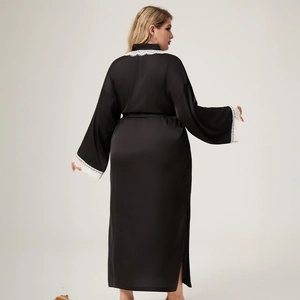 Long black satin bathrobe with white lace trim and kimono sleeves on a model