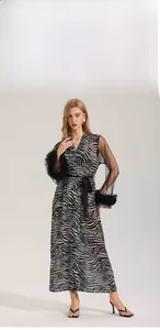 Detail of zebra print robe featuring sheer sleeves and elegant black faux feather cuffs