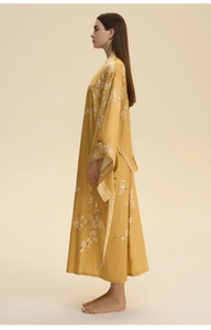Detail of yellow kimono robe with white crane and plum blossom print for beach coverup