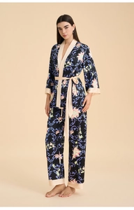 Detail of floral satin pajama set featuring silk-like texture and contrast piping trim