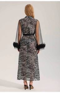 Detail of zebra print robe featuring semi-transparent mesh sleeves and ruffled cuffs
