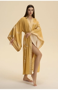 Detail of silk yellow kimono robe featuring delicate plum blossom embroidery and geometric borders