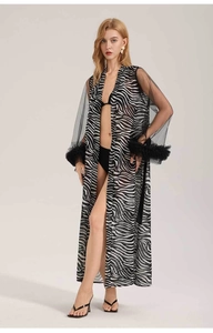Detail of zebra print chiffon robe featuring elegant sheer sleeves and feather trim cuffs