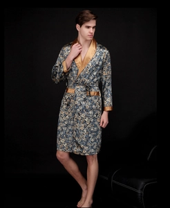 Detailed view of men's blue paisley silk robe with gold satin cuffs and trim detail