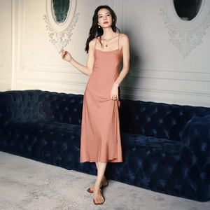 Elegant dusty pink satin slip nightdress shown on a model in a sophisticated setting