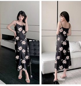 Detail of elegant black floral satin midi dress with delicate spaghetti straps and silk finish